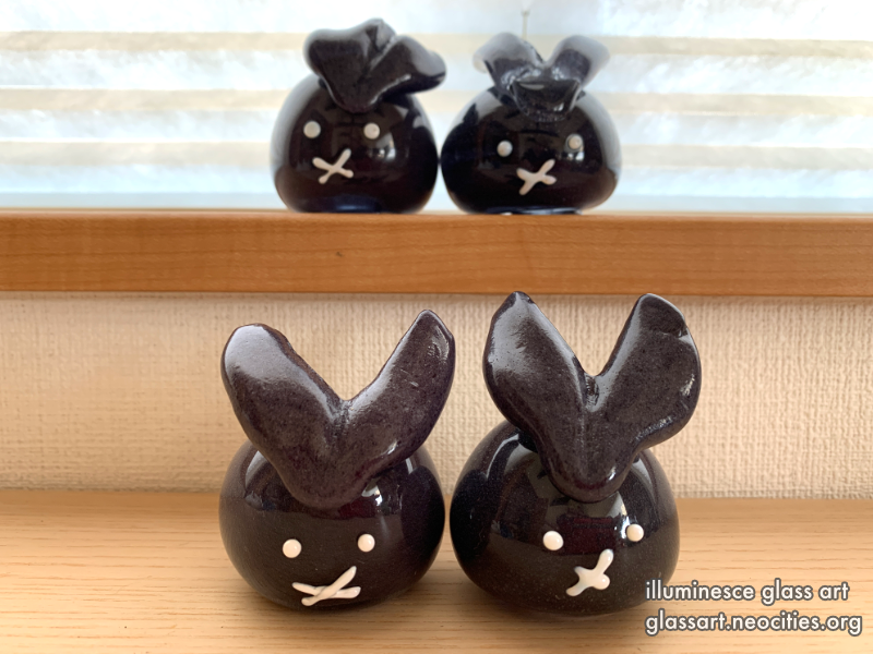 Four opaque black rabbits.