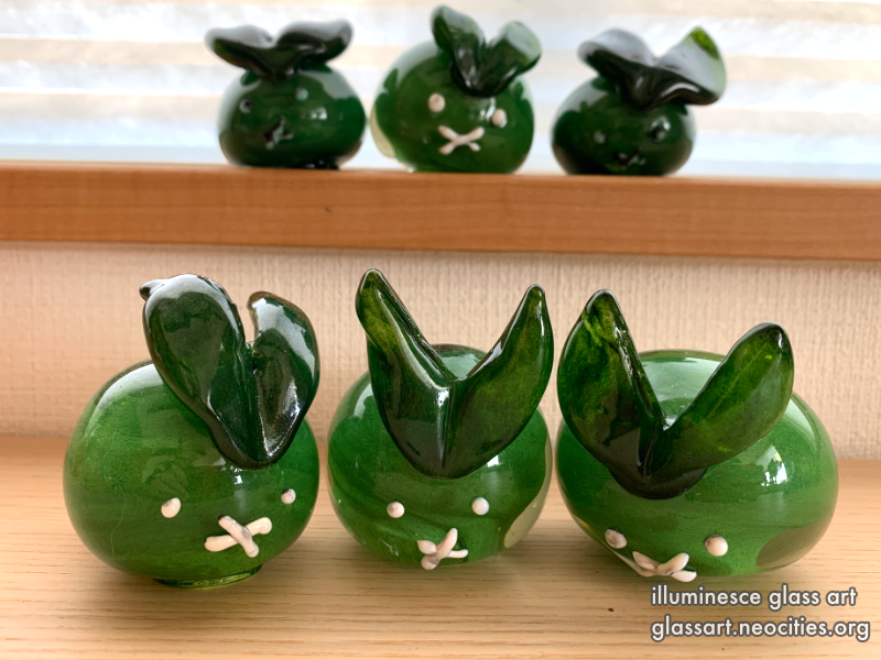 Four opaque green rabbits.